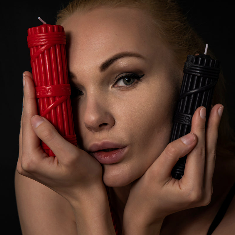 Model holding red sensual candle for body-safe dripping – Velalace