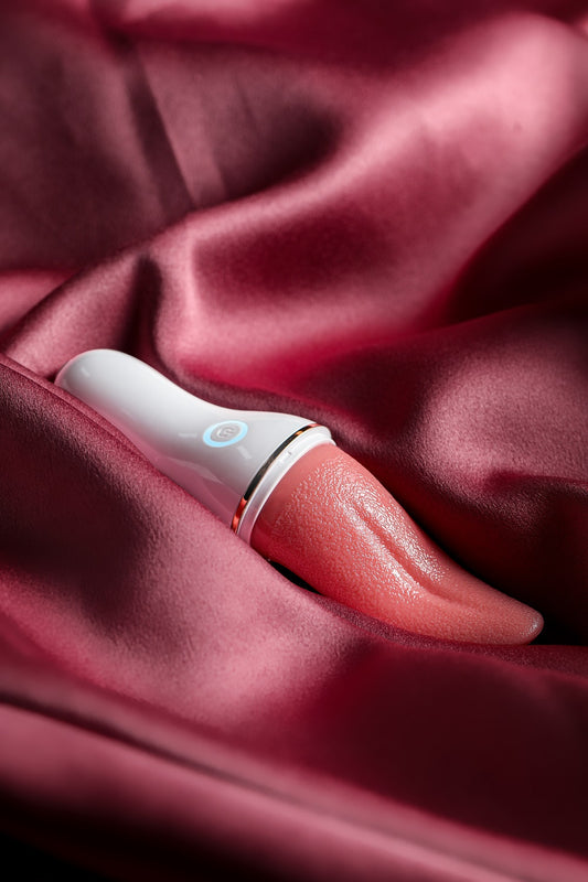Blazing Tongue Licking Vibrator – red tongue-shaped clitoral vibrator on satin background – Velalace